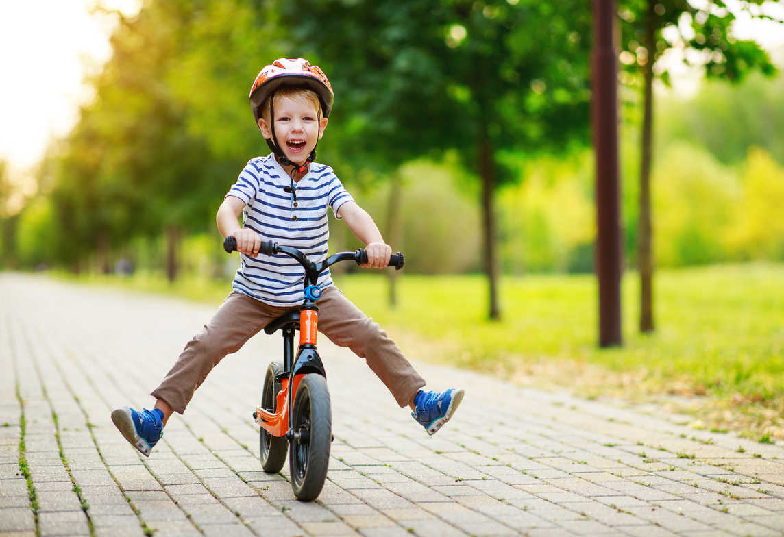 Kid learning to ride a balance bike